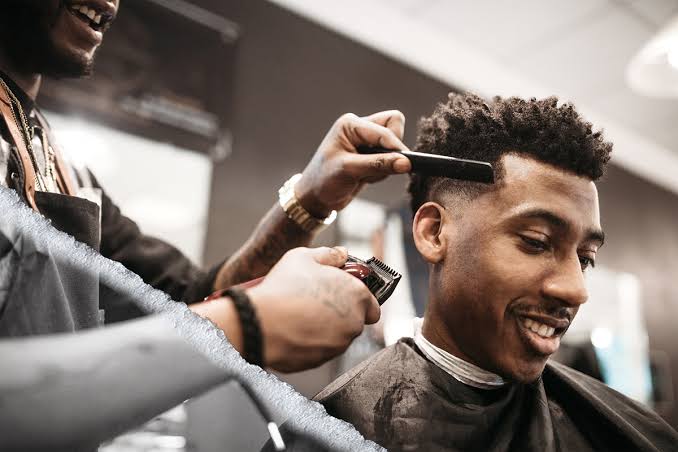 Barber fading a client's haircut